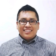 a man wearing glasses and a plaid shirt